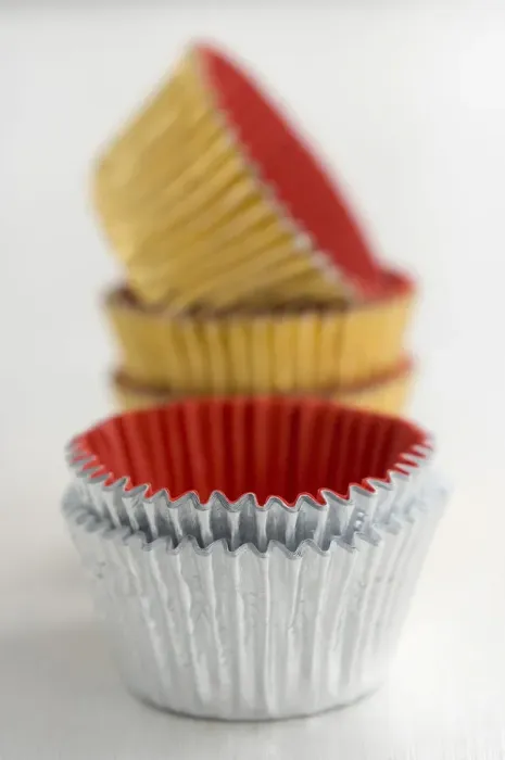 Framed Print : Stack of metallic muffins cases credit: Marie-Louise Avery  /  thePictureKitchen