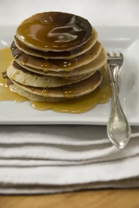 Framed Print : Stack of Scotch pancakes on white plate with silver fork and maple syrup credit Framed Print : Stack of Scotch pancakes on white plate with silver fork and maple syrup credit