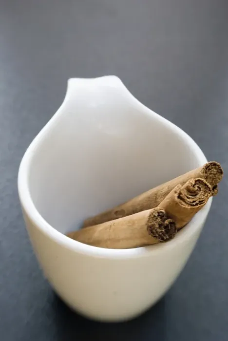 Framed Print : Sticks of cinnamon in small white cup credit: Marie-Louise Avery  /  thePictureKitchen