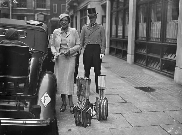Suzanne Lenglen with a dozen tennis rackets off for a day in the country. Mademoiselle
