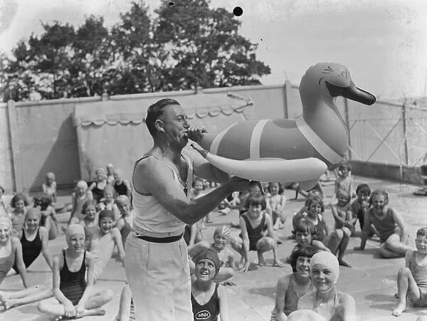 The Swanscombe Baths in Kent. Mr Bahalane blows up a swimming pool inflatable