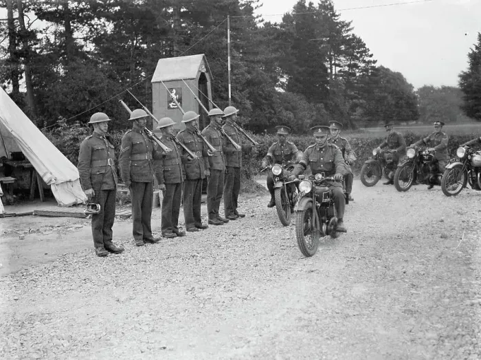 Framed Print : Territorial Army recruits at camp in Chichester, Sussex. Motorcyclists ride past Framed Print : Territorial Army recruits at camp in Chichester, Sussex. Motorcyclists ride past