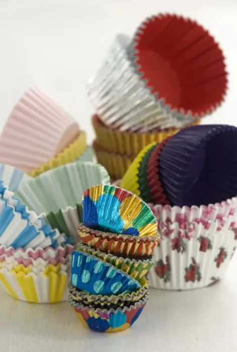 Framed Print : Variety of colourful muffin cases stacked high credit: Marie-Louise Avery  /  thePictureKitchen