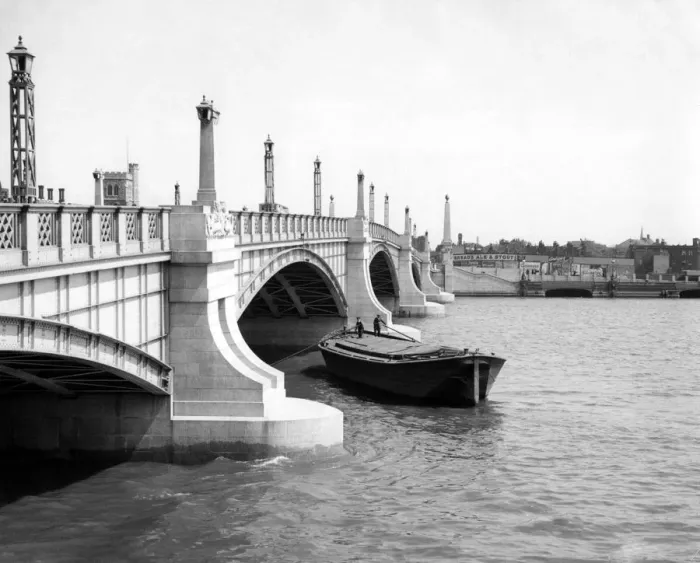 Framed Print : Watermen steering their barge underneath Lambeth Bridge, London