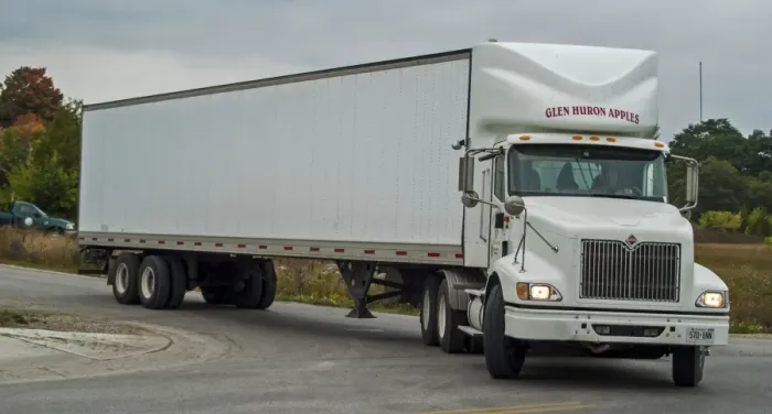 Framed Print : White International 6x4 semi tracter with a white twin axle box trailer turns right