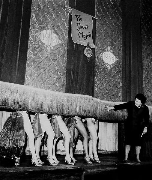 Windmill Theatre Owner Miss Sheila Van Dam watches as the curtain comes down over