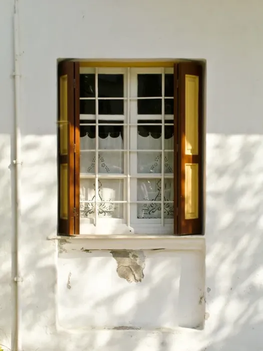 Framed Print : Window in white house in dappled sunlight with white embroidered cutwork curtain Framed Print : Window in white house in dappled sunlight with white embroidered cutwork curtain