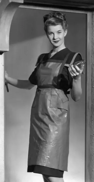 Framed Print : Woman in the 40s wearing an apron and holding a bottle 1947 Framed Print : Woman in the 40s wearing an apron and holding a bottle 1947