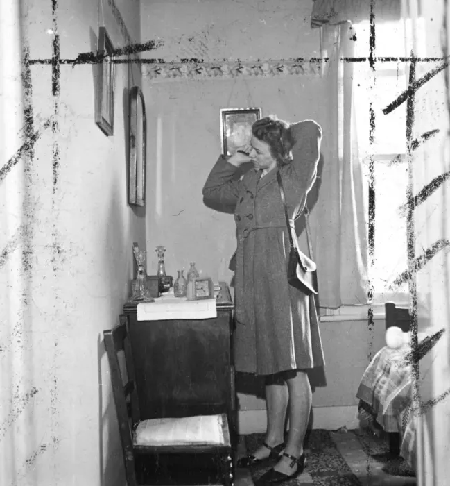 Framed Print : Woman brushing hair in front of the mirror in her bedroom. [no caption, location Framed Print : Woman brushing hair in front of the mirror in her bedroom. [no caption, location