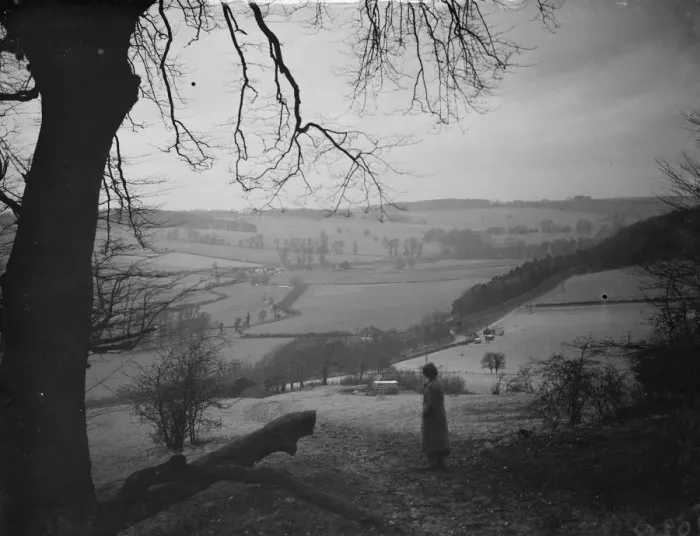 Framed Print : A women stands looking out at Preston hill farm estate. 3 February 1938
