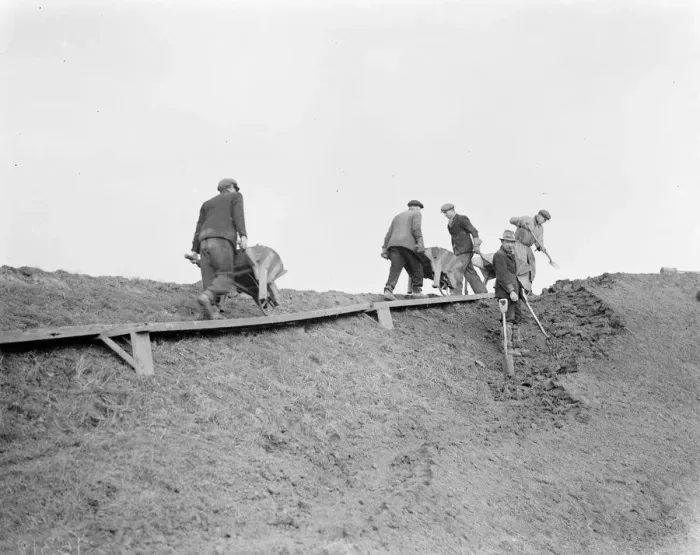Framed Print : Workers increasing the river defences and doing repairs on the river wall and embankment Framed Print : Workers increasing the river defences and doing repairs on the river wall and embankment