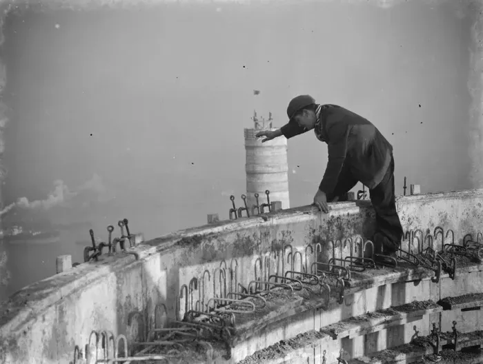 Framed Print : A workman waves down from one of the chimneys of the new coal electric power station