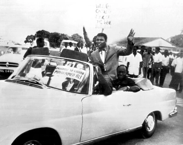 World Heavyweight Boxing Champion Cassius Clay rides in an open sports car as he