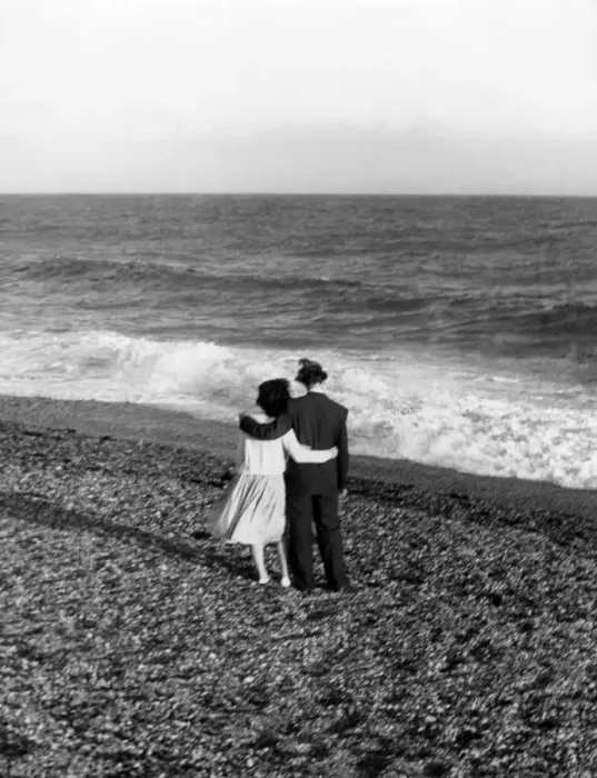 Framed Print : Young couple with their arms round each other enjoing the seaside Framed Print : Young couple with their arms round each other enjoing the seaside