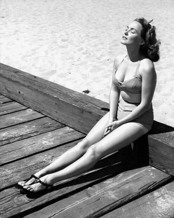 Framed Print : A young lady wearing a bikini and sandals sunbathing Framed Print : A young lady wearing a bikini and sandals sunbathing