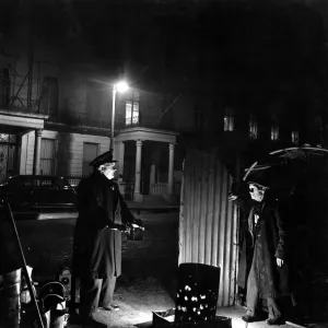 29 March 1952 Bill Howard a Romany night watchman in Belgrave Square, talking to