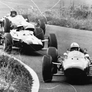 Adenau Germany John Surtees driving a Ferrari leads the pack in the second lap of