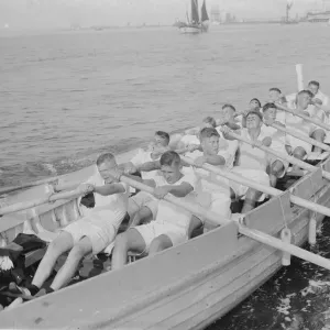 Cadets from HMS Worcester pulling on oars, Print