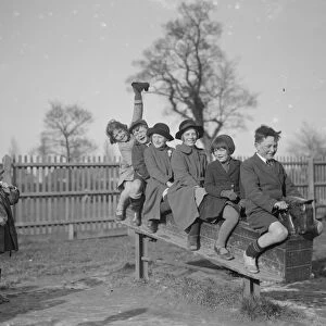 Children play on a rocking horse in a playground. 1936