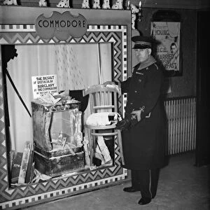 The cinema usher at the Commodore Theatre, Orpington standing by a display of the