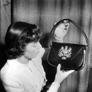Coronation Souvenir Mrs A Taylor holding a black handbag with coat of arms and Royal