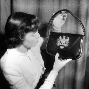 Coronation Souvenir Mrs A Taylor holding a black handbag with coat of arms and Royal Coronation Souvenir Mrs A Taylor holding a black handbag with coat of arms and Royal