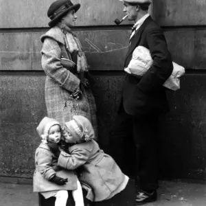 Print of a family under mistletoe on Christmas Day 1921 Print of a family under mistletoe on Christmas Day 1921