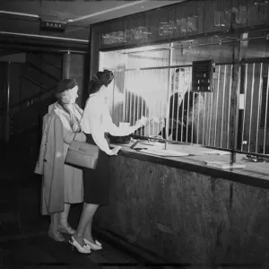 Customers at Midland Bank being attended to by a Bank Teller. 23 October 1946 Customers at Midland Bank being attended to by a Bank Teller. 23 October 1946