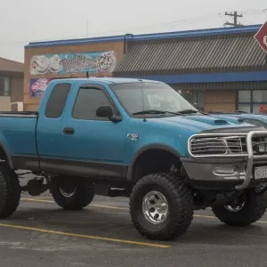 A customized Ford F150 with big wheels and tyres outside a Dairy Queen fast food