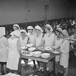 Dinner at East Central School in Dartford, Kent. The girls line up their food