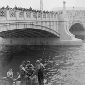 Diving in the Thames. A large crowd watched a diver Mr W R Gloss descend to