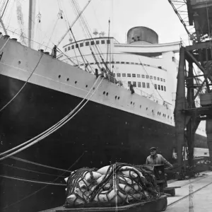 Dockers at Southampton were busy unloading a valuable cargo from the 85, 000 ton liner Dockers at Southampton were busy unloading a valuable cargo from the 85, 000 ton liner