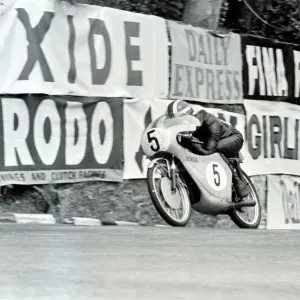 Douglas, Isle Of Man: Japans 1. Morishita pictured in action on his 50 c. c. Suzuki Douglas, Isle Of Man: Japans 1. Morishita pictured in action on his 50 c. c. Suzuki