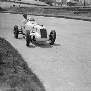 Driver, W Esplen in his supercharged MG taking the last hill on the new road track at Brooklands