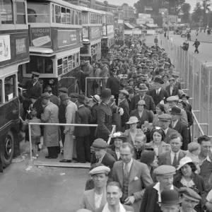 The Epsom Derby Summer Race Meeting. Derby Day crowds boarding buses at Morden
