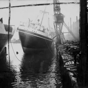 Print of the RMS Corinthic listing severely in a fire at Birkenhead Print of the RMS Corinthic listing severely in a fire at Birkenhead