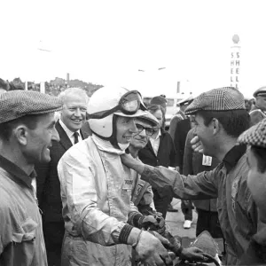 Friends and fans gather round to congratulate John Surtees after he won the German