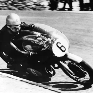 Gary Hocking, riding his MV Agusta into second place at the 350cc class in the Junior Gary Hocking, riding his MV Agusta into second place at the 350cc class in the Junior
