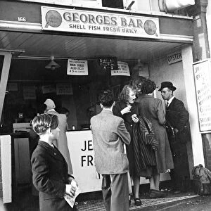 Georges Bar Shell Fish Fresh Daily A queue of people wait to be served but a woman