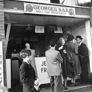 Georges Bar Shell Fish Fresh Daily A queue of people wait to be served but a woman Georges Bar Shell Fish Fresh Daily A queue of people wait to be served but a woman