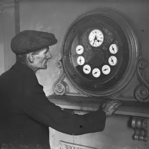 Gravesend Gasworks in Kent. A worker examines the gas meter main. 1939