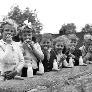 A group of children at Chedworth village school enjoy their meal, a print A group of children at Chedworth village school enjoy their meal, a print