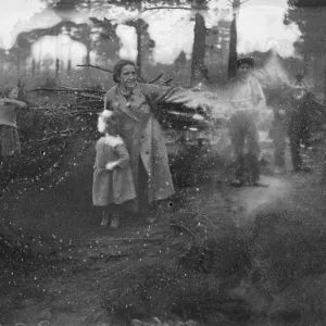 A gypsy family brings logs to make brooms outside their bender at the Hurtwood Hill encampment, 1934 A gypsy family brings logs to make brooms outside their bender at the Hurtwood Hill encampment, 1934