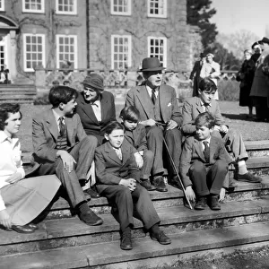 Harold MacMillan and his wife Lady Dorothy with their grandchildren on the steps of their home