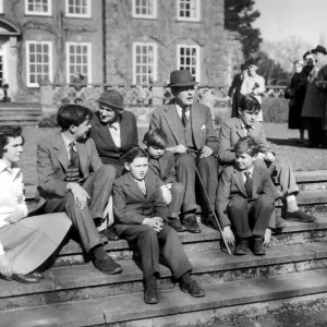 Harold MacMillan and his wife Lady Dorothy with their grandchildren on the steps of their home