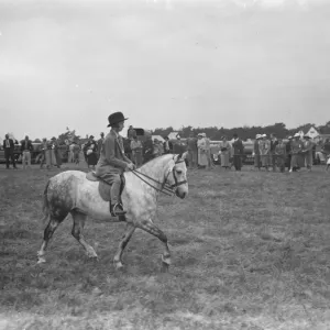 A horse show in Westerham, Kent. Young girl riding a pony. 1936