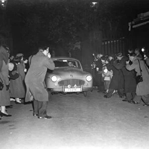 A host of press photographers descend upon the car belonging to Group Captain Peter