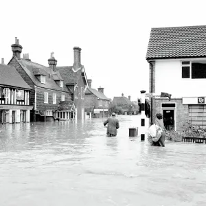 Householders salvaging what belongings they can - at the Southern end of High Street Edenbridge Kent on Sunday evening. Note the wellington boot stuck on the signpost! 11 September 1968 Householders salvaging what belongings they can - at the Southern end of High Street Edenbridge Kent on Sunday evening. Note the wellington boot stuck on the signpost! 11 September 1968