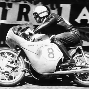 Isle of Man: Japanese rider Taniguchi on a Honda machine racing round the Manx track Isle of Man: Japanese rider Taniguchi on a Honda machine racing round the Manx track