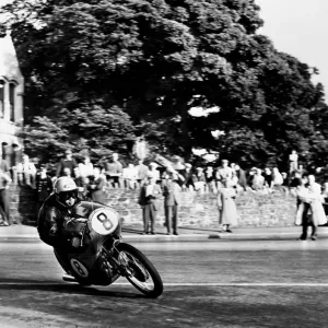 Isle of Man: N Taniguchi of Japan takes the corner at speed, riding a 125cc Japanese honda Isle of Man: N Taniguchi of Japan takes the corner at speed, riding a 125cc Japanese honda